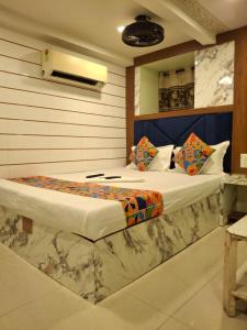 a bedroom with a large bed in a room at Venus Guest House in Mumbai