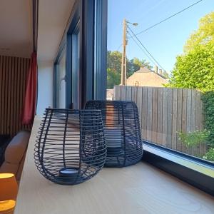 two chairs sitting on a balcony looking out a window at Gîte Entre Semois et Forêt in Chiny