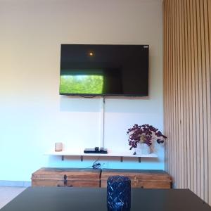 a flat screen tv hanging on a wall at Gîte Entre Semois et Forêt in Chiny
