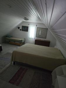 a bedroom with a large bed in a attic at Revontulet ZH Tuliaalto Moki in Pieksämäki +24 photos