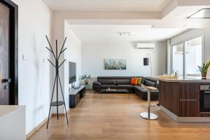 a living room with a couch and a table at Limassol Marina Seaview Suite in Limassol