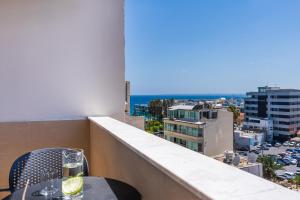 a balcony with a table and a view of a city at Limassol Marina Seaview Suite in Limassol