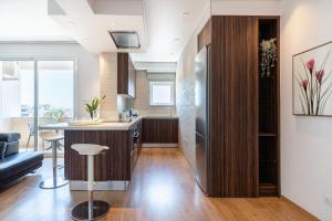 an open kitchen and living room with a bar and a couch at Limassol Marina Seaview Suite in Limassol