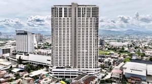 a tall building with a city in the background at Jtower residences mandaue 12th flr in Mandaue City
