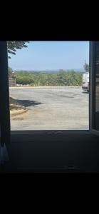 a view of a parking lot from a window at Chambre la paix lot in Payrac