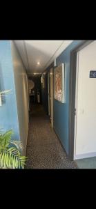 a hallway of a room with blue walls and a hallway at Chambre la paix lot in Payrac