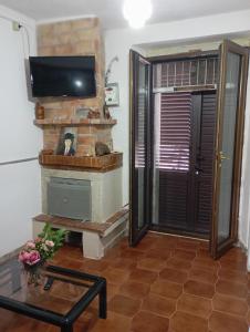 a living room with a fireplace and a flat screen tv at Bed And Breakfast ARIS in Benevento