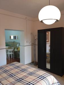 a bedroom with a bed and a refrigerator and a light at Bed And Breakfast ARIS in Benevento +6 photos