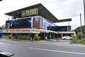 a building on the side of a city street at Paddyfield Inn in Mananthavady