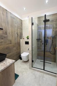 a bathroom with a toilet and a glass shower at MADISON RANCH in Szabolcsveresmart +32 photos