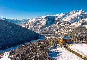 a resort in the mountains with snow covered mountains at Auberge du Belvédère in Séez