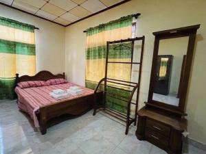 a bedroom with a bed and a mirror and a dresser at DIMORA Bologngna in Chilaw