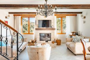 a living room with a fireplace and a chandelier at Villa Elena in Cetinje
