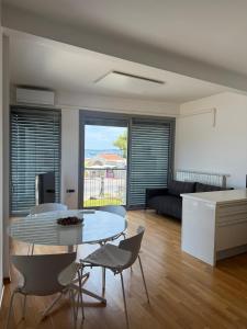 a living room with a table and chairs at Koper Sea Apartment in Koper