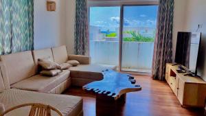 a living room with a couch and a table at Verdana House in Kiwengwa