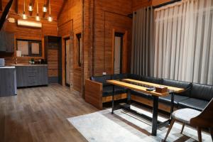 a living room with a table and a couch at Fayz Mount Residence in Chimgan