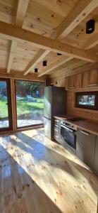 a kitchen in a tiny house with wooden ceilings at Bungalows Prokletije in Gusinje +65 photos