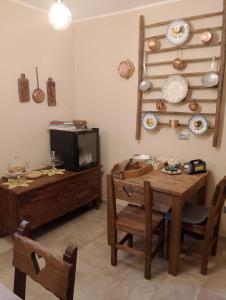 a dining room with a table and a tv at La Sosto de Cesi - B&B in Grange Pieccia +10 photos