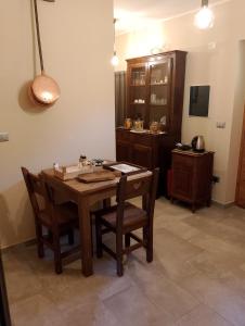 a dining room with a wooden table and chairs at La Sosto de Cesi - B&B in Grange Pieccia