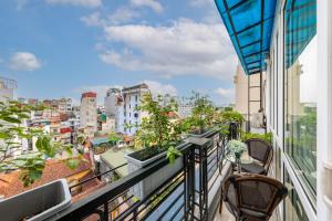 a balcony with chairs and a view of a city at Golden Amour Hotel in Hanoi