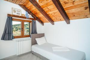 a bedroom with a bed and a window at Villa Elena in Cetinje