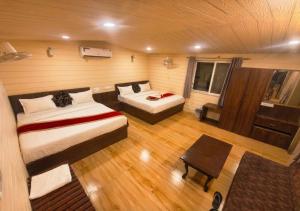 a view of a room with two beds and a table at Hotel Royal Palace in Chittaurgarh +13 photos