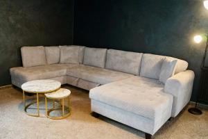 a living room with a couch and a table at Donovaly Residence Apartment 111 in Donovaly