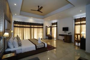 a bedroom with a bed and a desk in a room at Terrace Valley Hotel in Gangtok