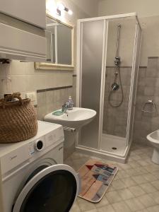 a bathroom with a washing machine and a sink at La Meridiana Apartment in Ghiffa +37 photos