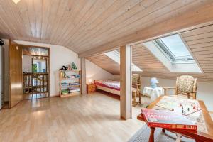 a attic room with a bed and a table at Haus "Sonnenblume" in Regenstauf