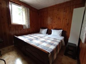a bedroom with a bed in a wooden room at Andrea's hays in Kobuleti