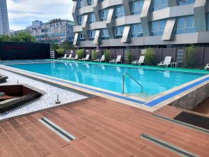 a swimming pool in front of a building at Sokcho Marina Hotel in Sokcho