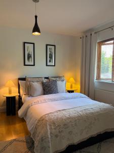 a bedroom with a large bed with two tables at Birch House Ballina in Ballina