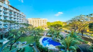 an overhead view of a resort with a pool and palm trees at 2BR Fully Air-Conditioned Staycation with Parking in Manila