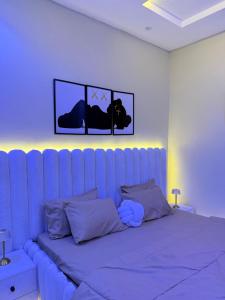a bed in a room with a blue at EK Escape and Suites in Ado Ekiti +9 photos