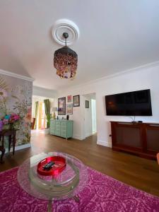 a living room with a table and a chandelier at Dunboyne Apartment in Dunboyne