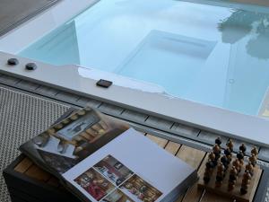 a chess game on a table next to a window at ALPENGARTEN EIGENTHAL - Private Wellness Retreat in Eigenthal