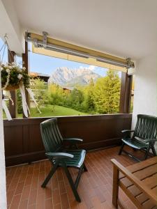 two chairs on a balcony with a view of a mountain at Ferienwohnung Hinterthal in Hinterthal