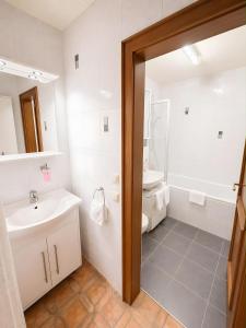 a white bathroom with a sink and a toilet at Ferienwohnung Hinterthal in Hinterthal