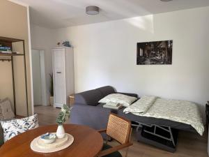 a living room with a couch and a table at Ferienwohnung Forêt de la Sprée - Werben Spreewald in Werben