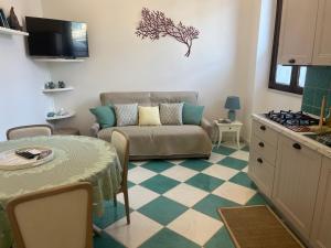 a living room with a couch and a table at Dimora Patrizia in Scario