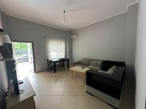 a living room with a couch and a table at Alexa Beach Apartment in Velipojë
