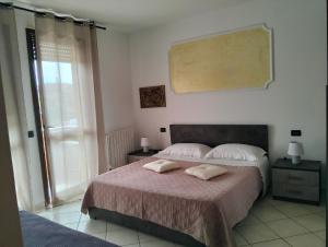 a bedroom with a bed with two pillows on it at Appartamento ai Noci in Padova