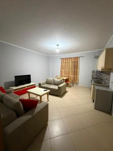 a living room with two couches and a table at Alexa Beach Apartment in Velipojë
