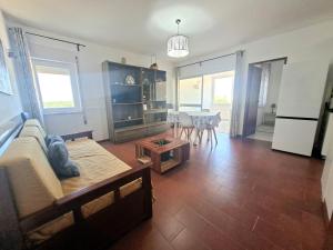 a living room with a couch and a table at Beach&Surf Flat in Aljezur