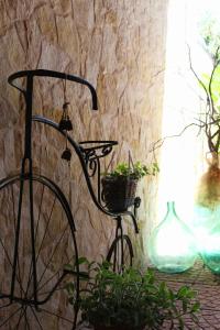 a black bike is attached to a stone wall at Le Casette della Murgia in Cassano delle Murge +121 photos
