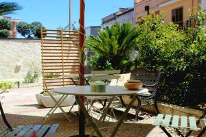 a table and chairs sitting on a patio at Le Casette della Murgia in Cassano delle Murge