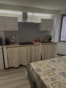 a kitchen with a table with a table cloth on it at B&B Pudzones in Santu Lussurgiu
