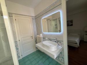 a bathroom with a sink and a mirror at B&B Vela Sea in Civitanova Marche