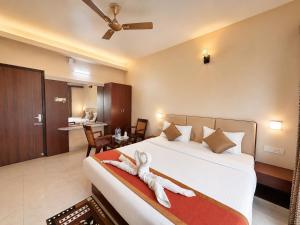 a bedroom with a bed with a stuffed animal on it at Hotel Golden Wave Puri - Baliapanda Housing Colony - Near Golden Beach- Parking - Restaurant in Puri